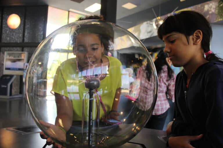 Two young girls at a STEM museum.